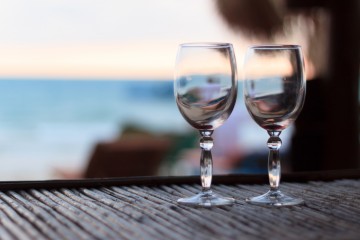 Beach evening on the sunset with two glasses